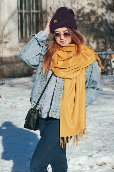 Street style Fashion portrait pretty young woman in trendy casual clothes, smiling, in sun glasses. Sunny winter day, city lifestyle
