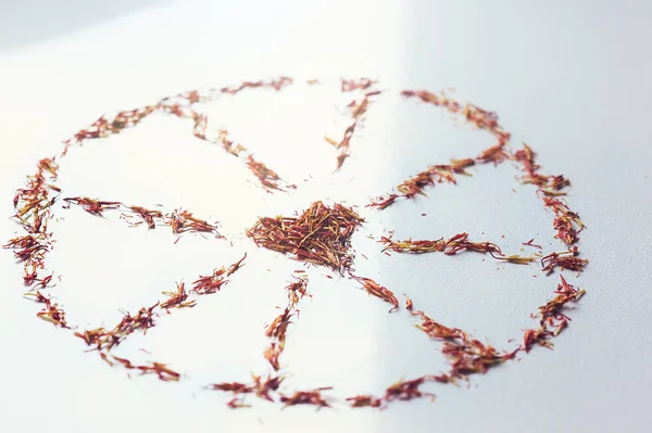 Selective focus close up Red Saffron in shape of circle with heart on white background. Delicate flower threads. Natural healthy spice. For cafe menu or catalog