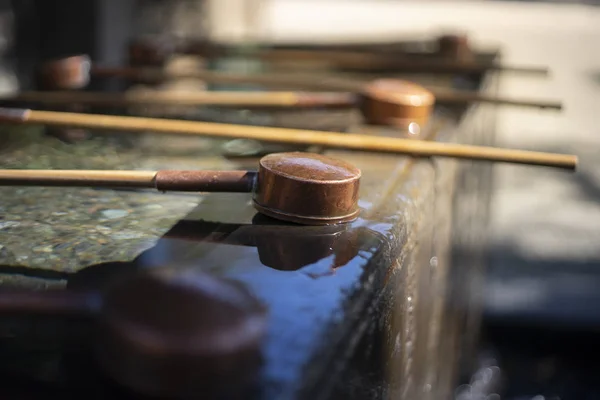 Mouth and hand washing bucket in front of Shrine or Temple.