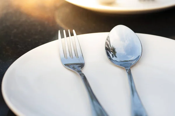 Spoon and fork on plate — Stock Photo, Image