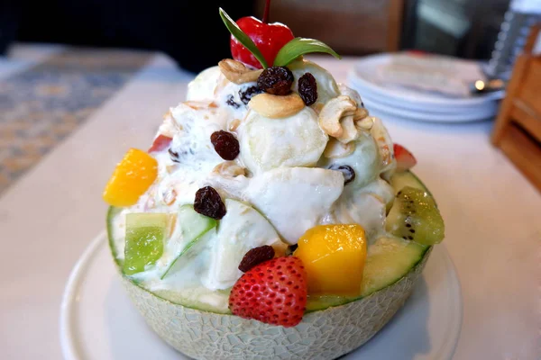 stock image Delicious Strawberry, Kiwi, Melon and Apple Fruit Salad in a Cantaloupe Bowl