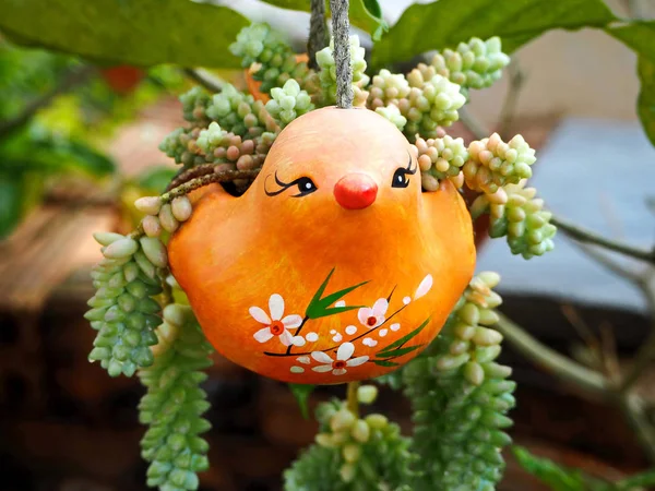 Lovely Orange Ceramic Bird Hanging Planter in the Garden