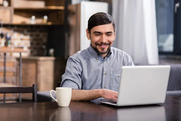 Online Work Cheerful Handsome Man Using His Laptop While Enjoying — Stock Photo, Image
