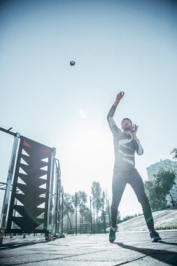 Spor sahasında antrenman yapıp havada top yakalayan profesyonel hevesli sporcu