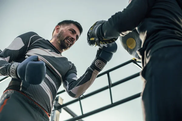 Boxeador Profesional Confiado Realizando Los Golpes Mientras Entrenador Usa Guantes —  Fotos de Stock