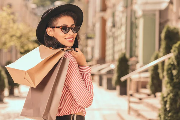 Happy Young Woman Sunglasses Hat Putting Shopping Bags Shoulder — Stock Photo, Image