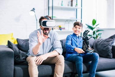 Oğlu ile robot test ederken Vr gözlük takan iyimser adam