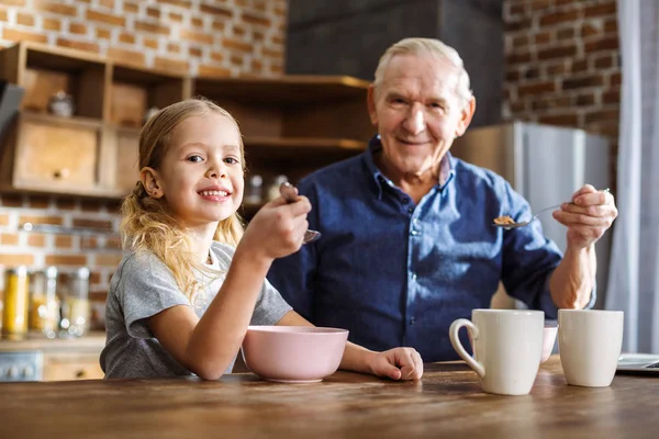 Segíts Magadon Örömteli Aranyos Kislány Nagyapja Miközben Élvezi Reggelit Konyhában — Stock Fotó