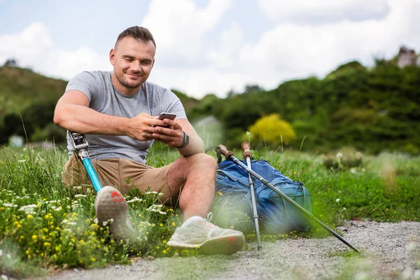 Delighted Young Man Disability Using His Phone While Resting Grass — Stock Photo, Image