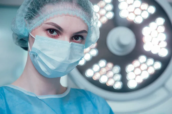 Luz Brilhante Lâmpada Cirúrgica Retrato Uma Bela Médica Uma Máscara — Fotografia de Stock