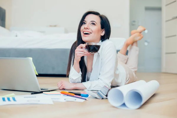 Happy Female Designer Lying Blueprints Stationery Supplies Looking Distance While — Stock Photo, Image