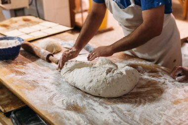 Baker ekmek fırın rustik bir tablo hazırlamak için hamur yoğurma. Geleneksel ekmek kavramı.