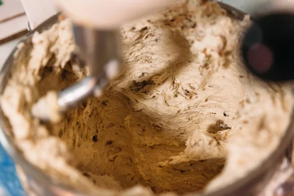 An industrial dough mixer is kneading dough to make bread in an artisanal bakery. Traditional Bakery Concept.