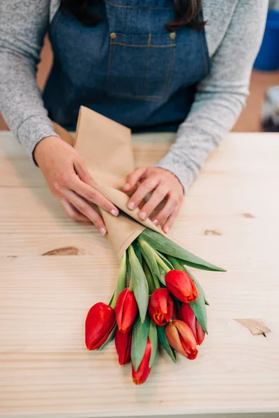 Mann Florist Macht Roten Tulpenstrauß Und Verpackung Packpapier Auf Holztisch — Stockfoto