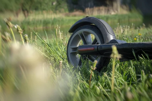 Tylne koło skutera elektrycznego na trawie łące — Zdjęcie stockowe