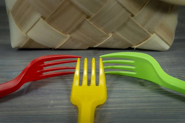 Plastic forks and tipped wicker basket