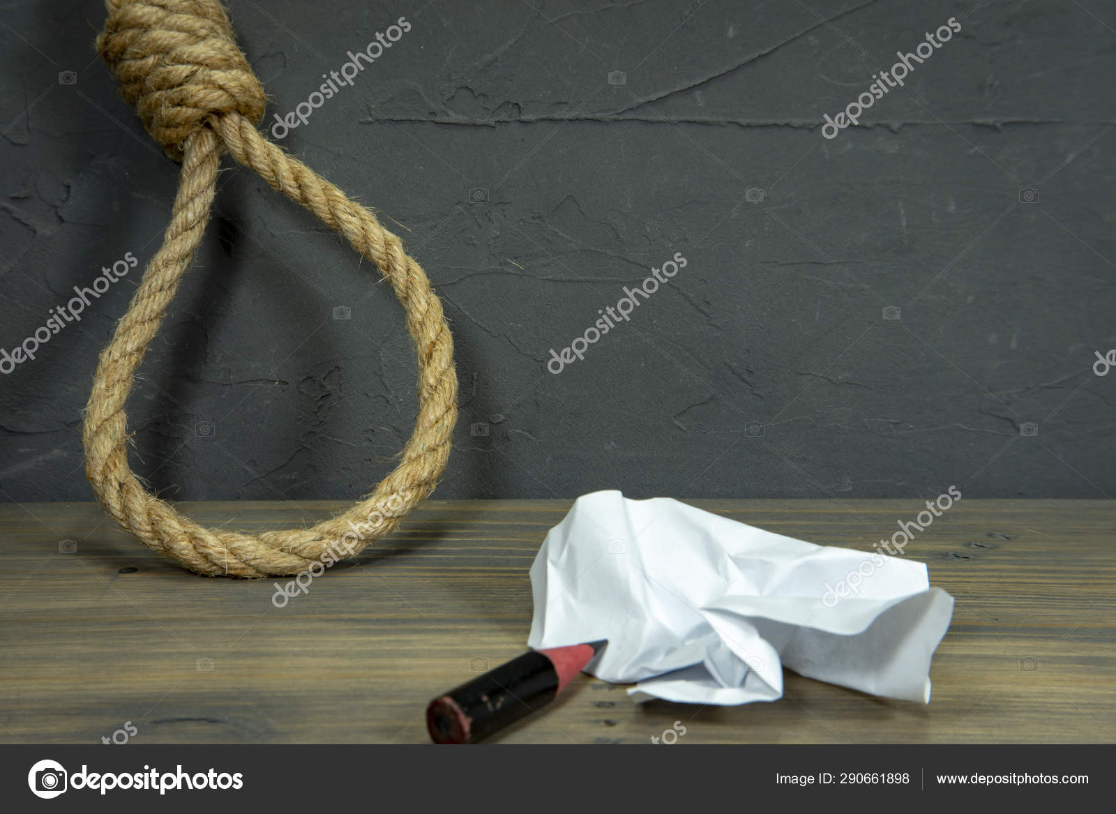 Rope Noose Around Crumpled Paper And Pencil Stock Photo