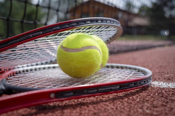 Tennis scene with black net, balls and racquet