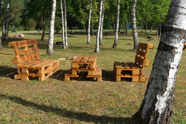 Rustic wooden table and benches at a lake
