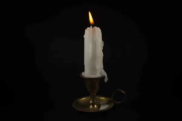 Burning wax candle in a vintage brass candlestick — Stock Photo, Image