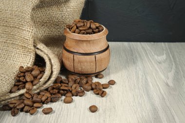 Kavrulmuş kahve çekirdekleri, ahşap tencere ve jüt çuval