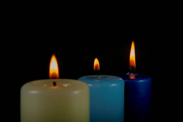 Close up of three colorful wax candles flame — Stock Photo, Image