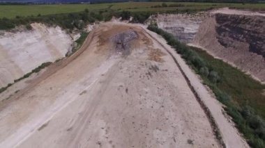 Kazıcı çöp hurdalıkta taşır. Hava atışı.