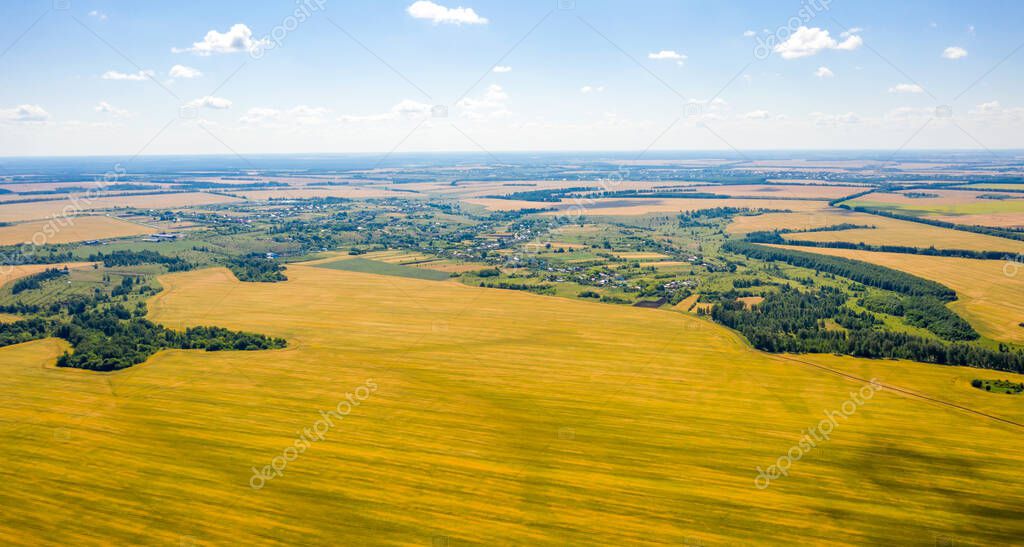view from the top of the village surrounded on all sides by colorful fields