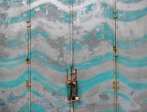 a silver and turquoise painted garage door in Alicante Spain