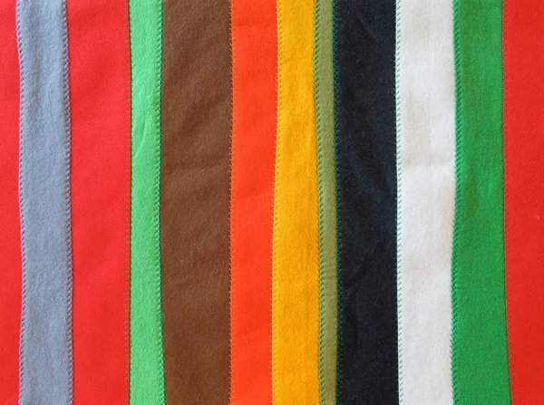 Coverlet made of long strips of felt  in different colors sewn t — Stock Photo, Image