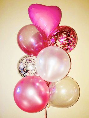 A very beautiful composition of helium balloons of white and pink mother-of-pearl color, balloons with silver and pink sparkles, as well as transparent helium balloons with silvery confetti and fuchsia-colored confetti and a mirror star. clipart