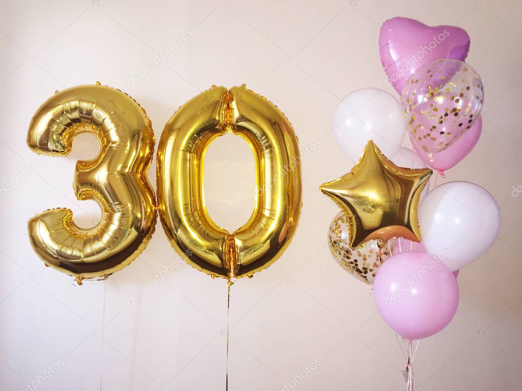 Composition of helium balloons white, pink, transparent with confetti, as well as a gold star and a large figure of thirty golden colors. Gift for 30 years for a girl