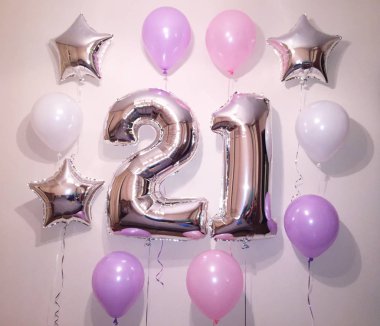Kompozisyon helyum balonlar beyaz, pembe, leylak, gümüş yıldız ve büyük gümüş sayılar olan 21. Güzel bir kızın Doğum günü için sürpriz