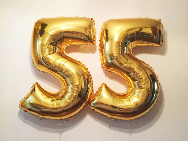 Number 55 - helium balloons of gold color. Congratulations on the anniversary