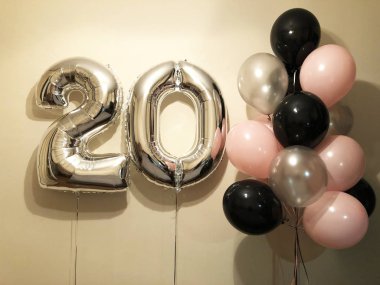 Beyaz, pembe, konfeti, şeffaf yanı sıra altın yıldız ve büyük bir rakam yirmi gümüş renk kompozisyonu helyum balonlar. 20 yıl boyunca bir kız için hediye