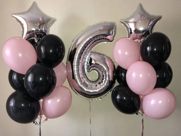 Composition of helium balloons black, pink, as well as a silver star and a large figure of six silver colors. A present to the girl for 6 year