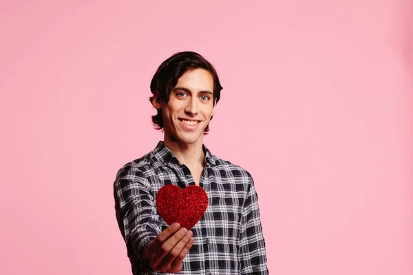 Sweet guy with big smile holding a red heart, be my Valentine