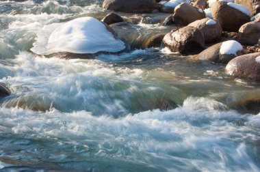 su küçük bir nehir erken ilkbahar akarsu. Bahar sahne. donmuş bir dere ile dağ manzarası