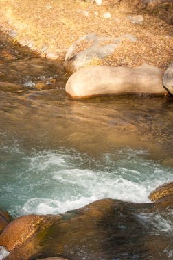 su küçük bir nehir erken ilkbahar akarsu. Bahar sahne. donmuş bir dere ile dağ manzarası