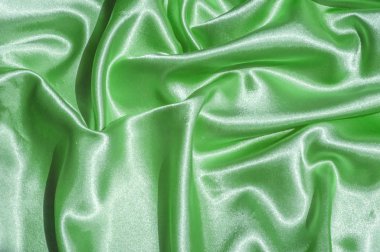 Doku, kumaş, arka plan. Lüks kumaş ya da sıvı dalgalar ya da dalgalı kırışık ipek saten doku kadife malzeme ya da lüks Noel ya da zarif arka plan arka plan. Yeşil