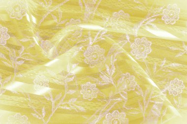 Doku, arka plan, desen. Sarı bez kumaş kumaş kumaş arka plan üzerinde. Sarı Pembe dantel çiçek kumaş close-up. Sarı dantelli çiçek kumaş Close-Up