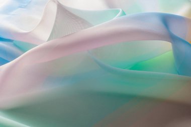 Doku, arka plan, desen. İpek kumaş şeffaf, sarı-pembe yeşil mavi olduğunu. Soyut yumuşak şifon doku arka plan. 