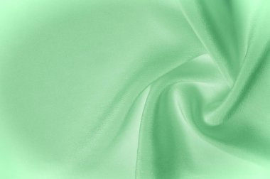 Doku arka plan deseni. Yeşil ipek kumaş. Closeup oluklu yeşil ipek kumaş. Reklam alanı. Pürüzsüz zarif yeşil ipek düğün arka plan olarak kullanılabilir.