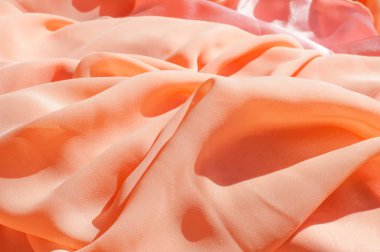 Doku, arka plan, desen. Açık turuncu renkli, ipek topu cüppe elbise. Kumaş mercan ipek