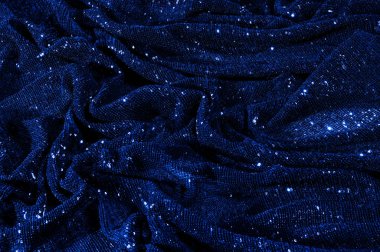  ile mavi kumaş. Göz alıcı bir ilişki için bu mavi maske spor. Dairesel çocuk sparkles yoğun bir düzenleme tüm kaplama için düz örgü gücü kapsamında kalır