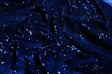  ile mavi kumaş. Göz alıcı bir ilişki için bu mavi maske spor. Dairesel çocuk sparkles yoğun bir düzenleme tüm kaplama için düz örgü gücü kapsamında kalır