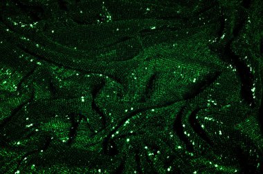 Doku, arka plan, desen, ile yeşil kumaş. Payetler payetler bu kumaş üzerine her açıdan göz kapmak üst üste gelen düz çizgiler içine dikilir ile bir açıklama yapmak.