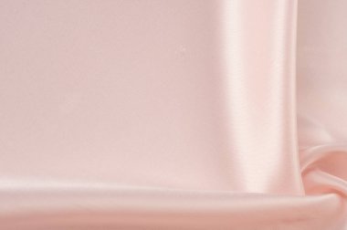 Doku, arka plan, desen. Kumaş ipek pembe arka plan. Güzel pembe saten. Perdelik arka plan. rüzgarlar dalgalar, kıvrımları güzel bir arka plan oluşturma.