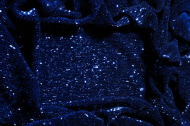  ile mavi kumaş. Göz alıcı bir ilişki için bu mavi maske spor. Dairesel çocuk sparkles yoğun bir düzenleme tüm kaplama için düz örgü gücü kapsamında kalır