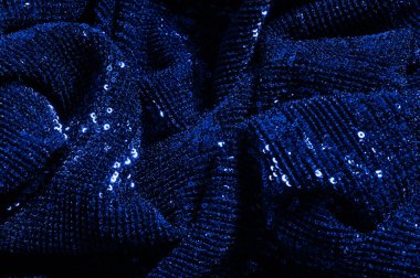  ile mavi kumaş. Göz alıcı bir ilişki için bu mavi maske spor. Dairesel çocuk sparkles yoğun bir düzenleme tüm kaplama için düz örgü gücü kapsamında kalır